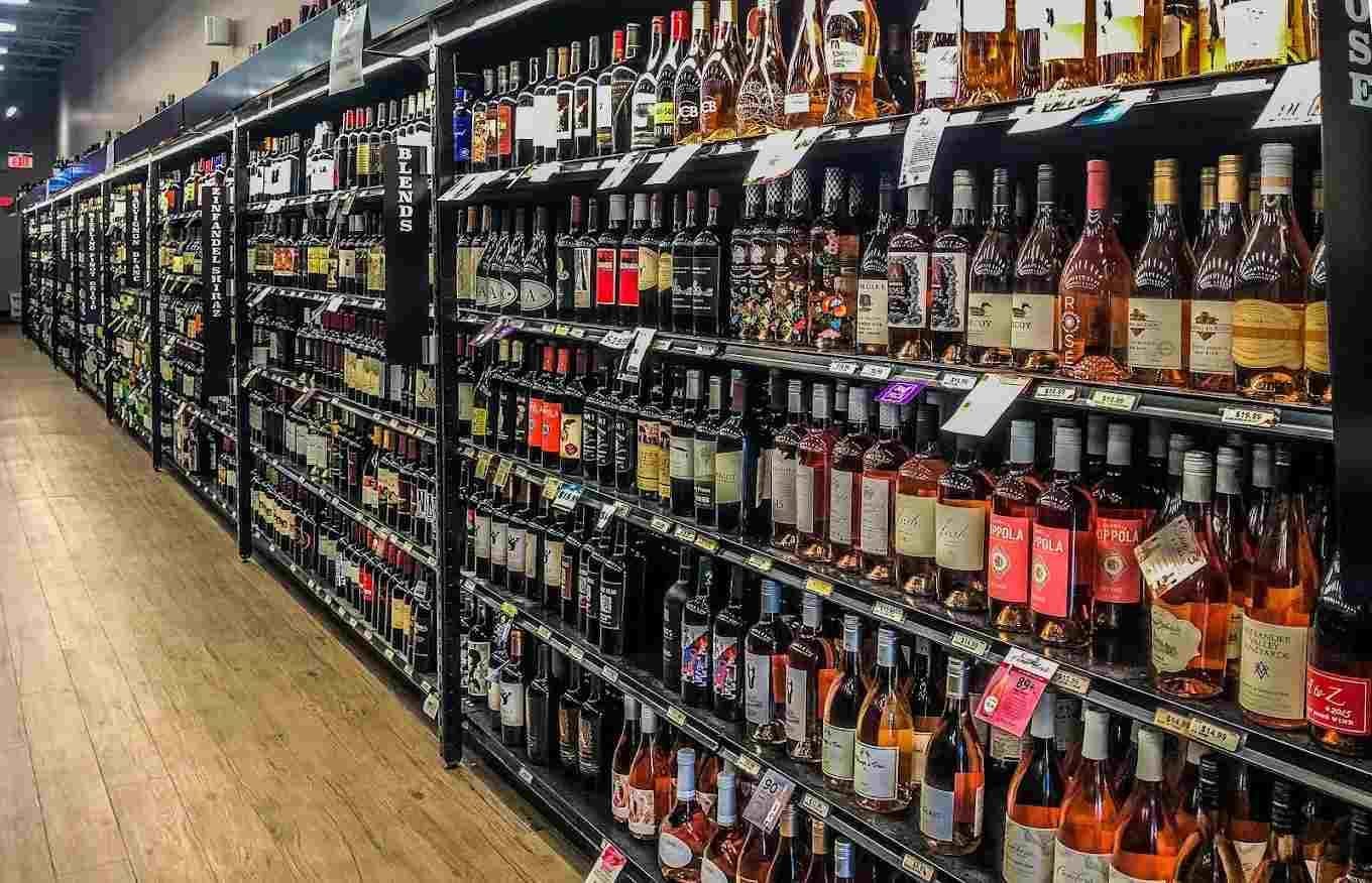 A long aisle of wine bottles inside Taunton Forge Liquors
