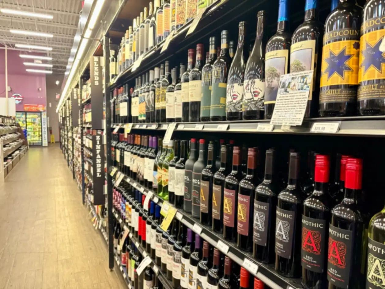 Red and white wines lining the wine aisle